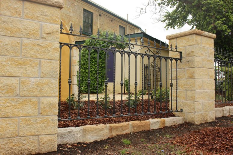 What are the main components of a wrought iron fence?